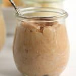 compound butter in a glass jar with a spoon, now infused with cinnamon and sugar.