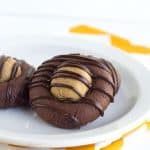 Two Buckeye Thumbprint Cookies on a plate.