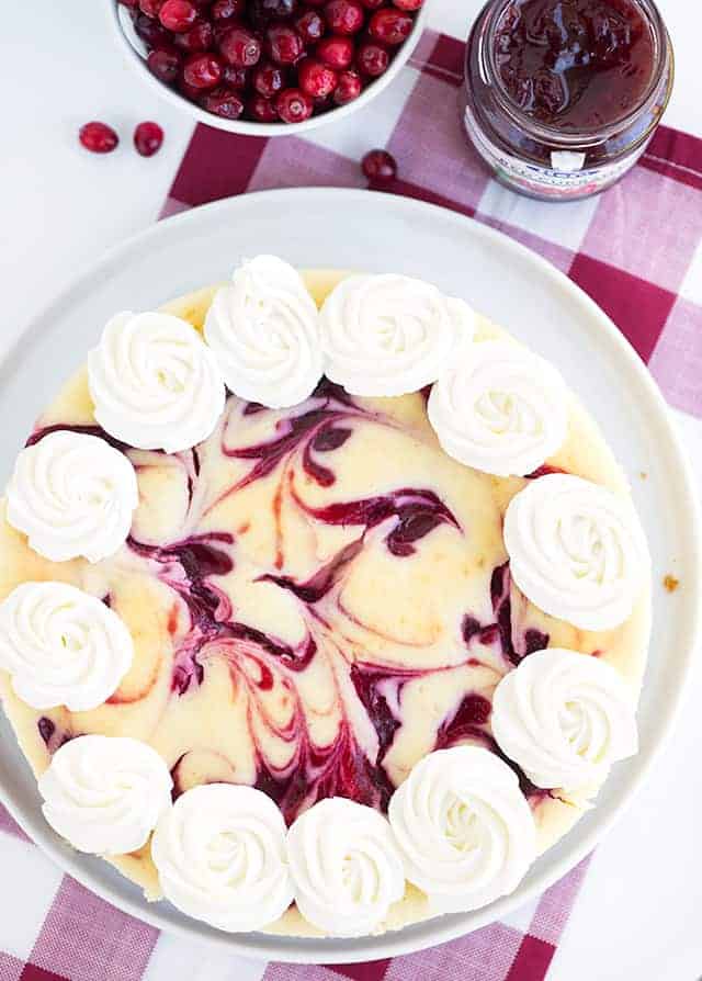 Cranberry Red Currant Cheesecake - Creamy vanilla cheesecake with swirls of cranberry and red currant throughout it. This cheesecake is perfect for the holidays!