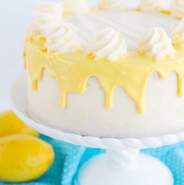 cake on white cake plate with yellow drizzle