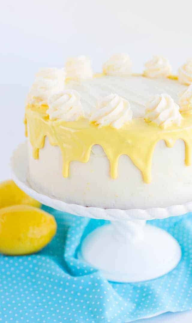 cake on white cake plate with yellow drizzle