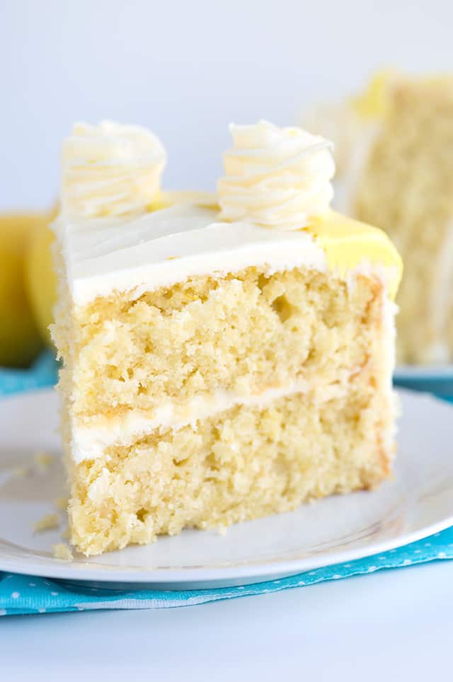 a slice of lemon olive oil layer cake with cream cheese frosting