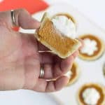 A hand holding a Mini Maple Pumpkin Pie.