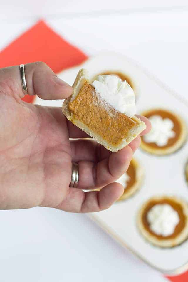 A hand holding a Mini Maple Pumpkin Pie.