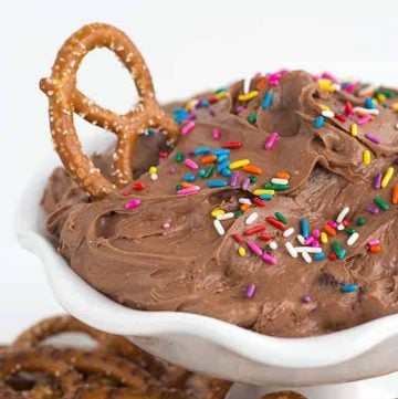 Chocolate pretzel dip in a white bowl with sprinkles, resembling brownie batter.