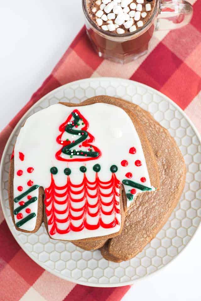 bite taken out of hot cocoa cookies on white plate