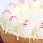 white chocolate peppermint cheesecake with a drizzle of white chocolate down the sides