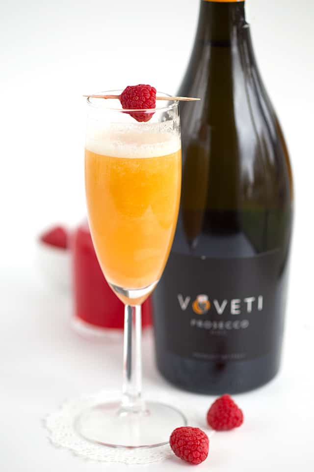 Peach Raspberry Bellini - raspberry infused simple syrup, peach puree, and sparkling wine come together to make a great fruity bellini! This is a drink for any and all occasions!