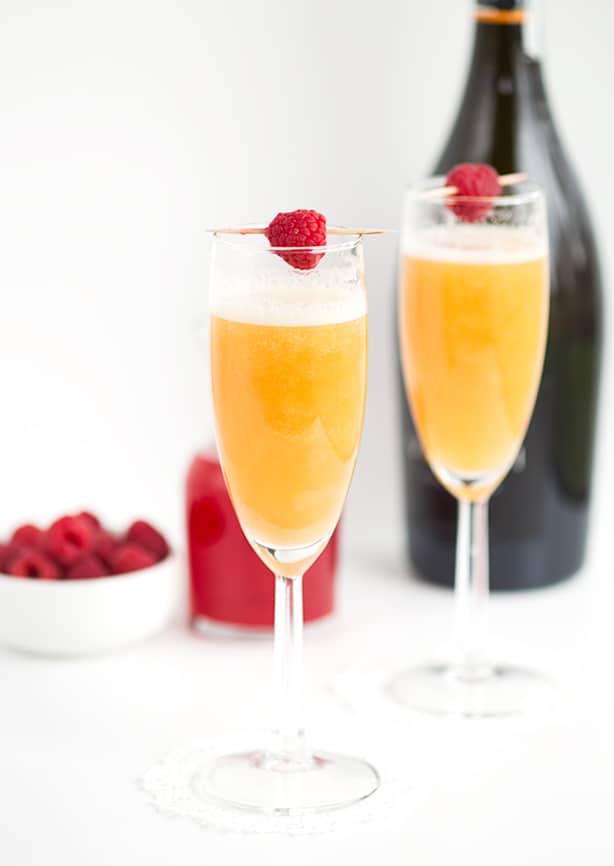 Peach Raspberry Bellini - raspberry infused simple syrup, peach puree, and sparkling wine come together to make a great fruity bellini! This is a drink for any and all occasions!