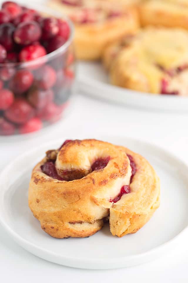 One cranberry orange cinnamon roll on a plate