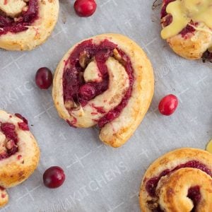 Cranberry orange rolls on a baking sheet.