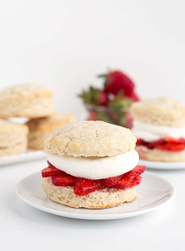 Homemade Strawberry Shortcake Recipe - Warm summer days are coming and this is the perfect cool, refreshing dessert to finish a day with. They're made with homemade sweetened buttermilk biscuits, fresh whipped cream, and macerated fresh strawberries. #cookiedoughandovenmitt #summerdessert #strawberries #dessertrecipes #dessertfoodrecipes