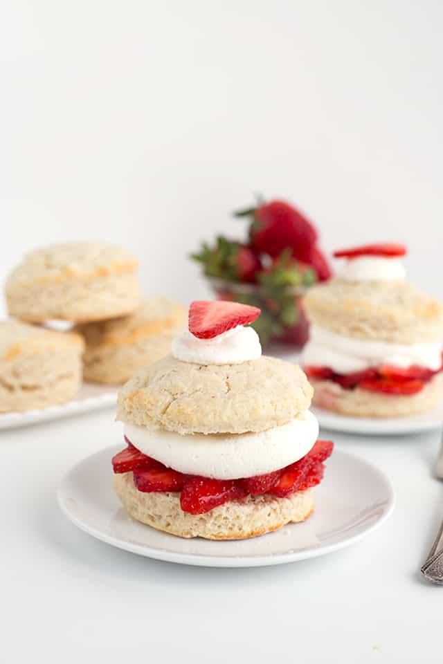 Homemade Strawberry Shortcake Recipe - Warm summer days are coming and this is the perfect cool, refreshing dessert to finish a day with. They're made with homemade sweetened buttermilk biscuits, fresh whipped cream, and macerated fresh strawberries. #cookiedoughandovenmitt #summerdessert #strawberries #dessertrecipes #dessertfoodrecipes