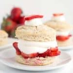Homemade strawberry shortcakes topped with whipped cream and fresh strawberries.