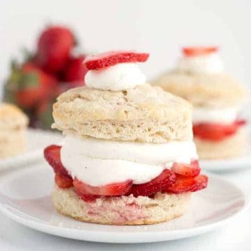 Homemade strawberry shortcakes topped with whipped cream and fresh strawberries.