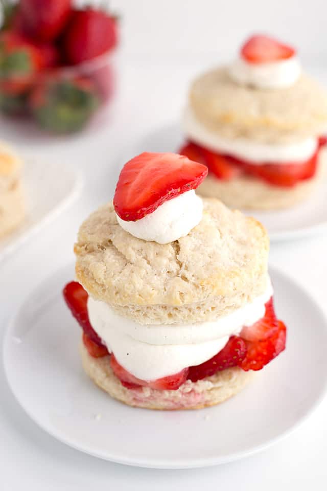 Homemade Strawberry Shortcake Recipe - Warm summer days are coming and this is the perfect cool, refreshing dessert to finish a day with. They're made with homemade sweetened buttermilk biscuits, fresh whipped cream, and macerated fresh strawberries. #cookiedoughandovenmitt #summerdessert #strawberries #dessertrecipes #dessertfoodrecipes