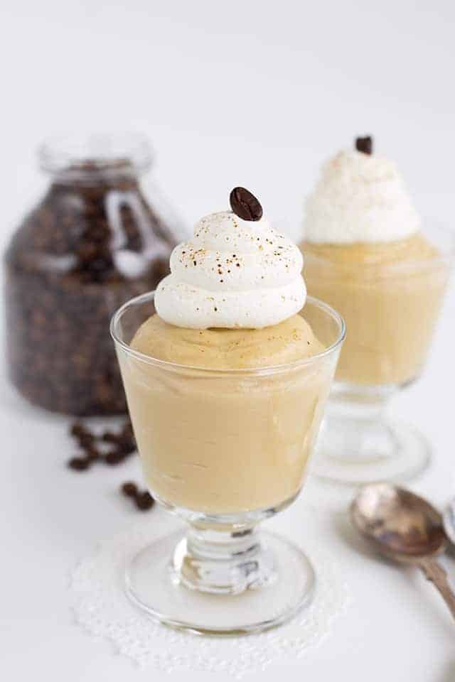 coffee pudding in glass serving cups with whipped cream on top