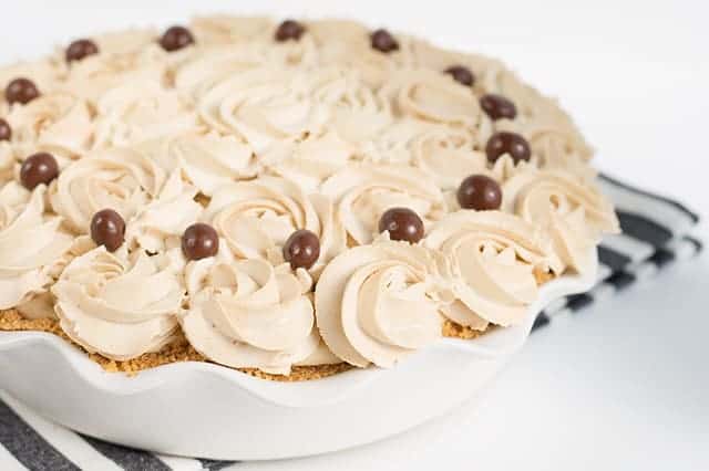Frozen Coffee Cream Pie - Start summer off with a frozen coffee cream pie! The pie is made with a homemade cold brew coffee pudding, cream cheese, and homemade whipped cream! It’s a great pie to make ahead and then partially thaw and serve later! #pie #cookiedoughandovenmitt #coffee #frozenpie #dessertrecipes #pierecipe #dessertfoodrecipes