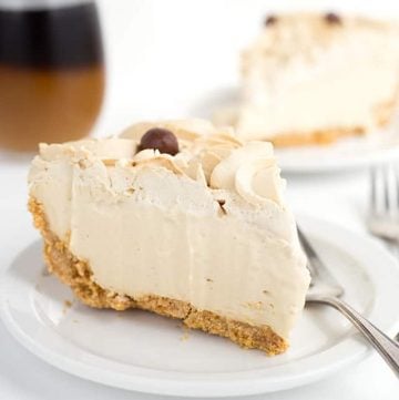slice of frozen coffee cream pie on a white plate with another slice in the background