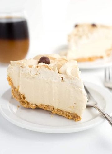 slice of frozen coffee cream pie on a white plate with another slice in the background