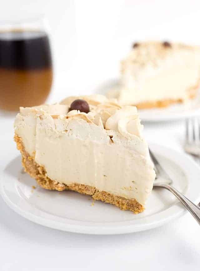 slice of frozen coffee cream pie on a white plate with another slice in the background