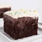 A slice of chocolate cake on a white plate.