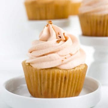 A plate of cupcakes on a white plate.