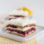 Blueberry lemon icebox cake on a white plate with yellow polka dotted linen