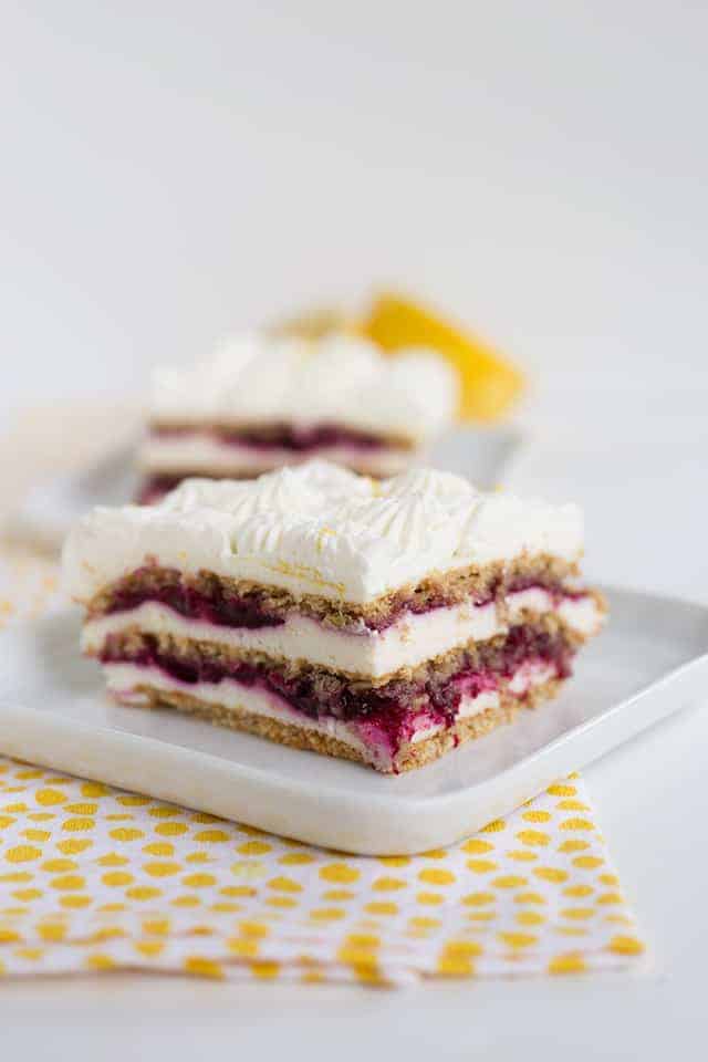 Blueberry lemon icebox cake on a white plate with yellow polka dotted linen