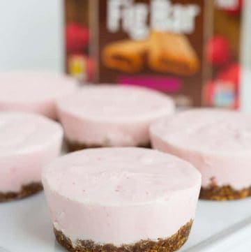 Close up of mini raspberry frozen yogurt pies on white plate