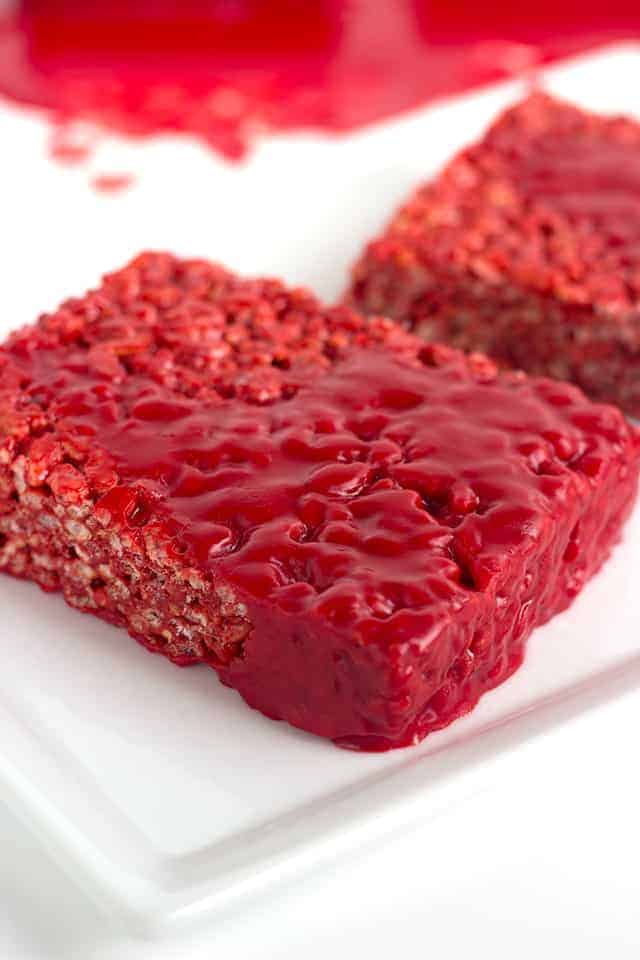 close up of bloody red velvet rice krispie treat on a white plate