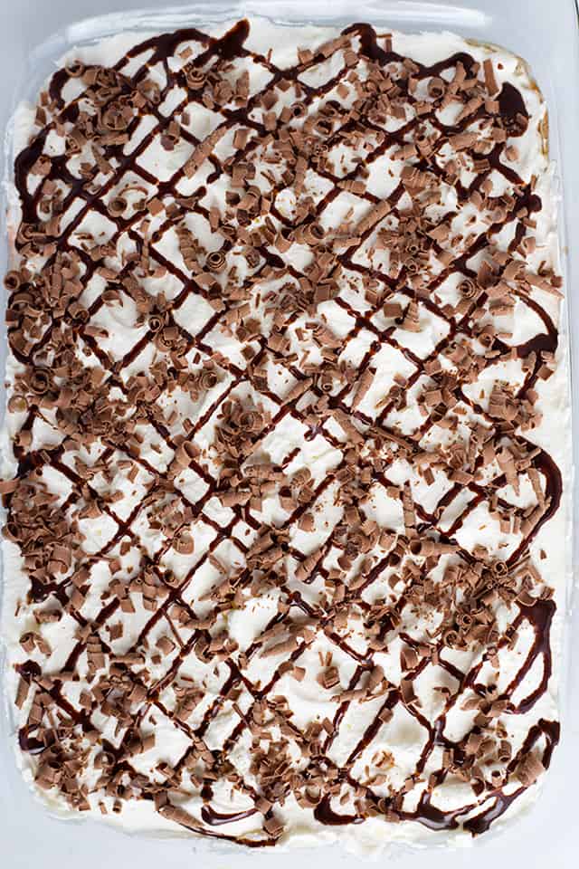 Chocolate Lasagna - This chocolate lasagna is the perfect no-bake summer dessert. It has a chocolate cookie crust, cream cheese, chocolate ganache, pudding, and whipped cream. It's so easy to make and people will go crazy for it every single time. It's like biting into a soft, fluffy chocolate cloud on top of a cookie crust. #cookiedoughandovenmitt #chocolate #dessertrecipes #dessertfoodrecipes #dessertable #nobake #nobakedesserts