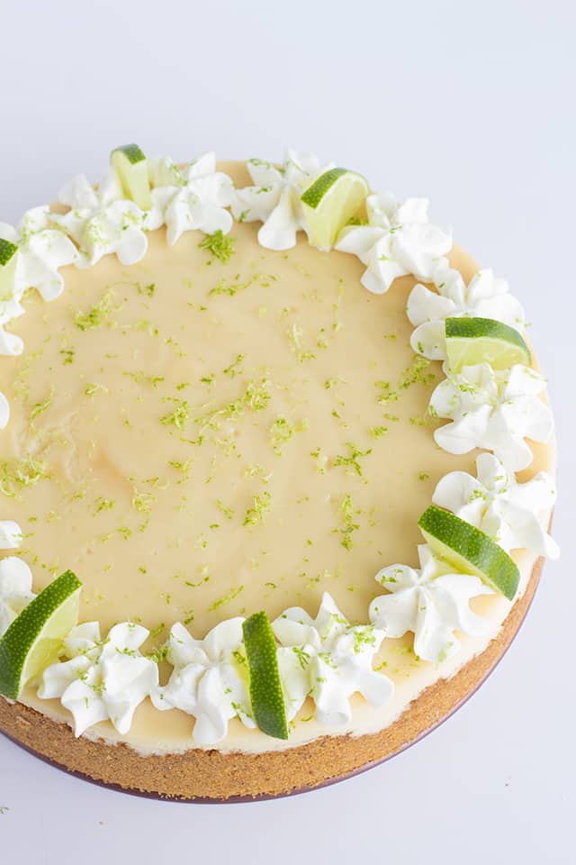 Key Lime Cheesecake - This key lime cheesecake is a fun spin on the key lime pie. It's so thick and creamy! Did I mention it has the perfect balance of sweet and tangy?! As far as the perfect summer dessert, this key lime cheesecake is the total package. #cookiedoughandovenmitt #cheesecake #cheesecakes #summerdessert #dessertfoodrecipes #dessertrecipes