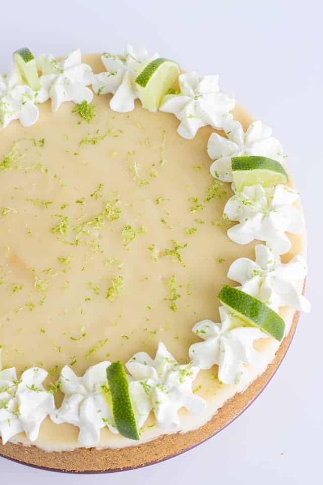 Key Lime Cheesecake - This key lime cheesecake is a fun spin on the key lime pie. It's so thick and creamy! Did I mention it has the perfect balance of sweet and tangy?! As far as the perfect summer dessert, this key lime cheesecake is the total package. #cookiedoughandovenmitt #cheesecake #cheesecakes #summerdessert #dessertfoodrecipes #dessertrecipes