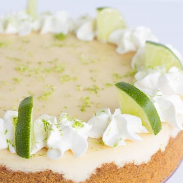 Close up showcasing the whipped cream and lime slices on the key lime cheesecake