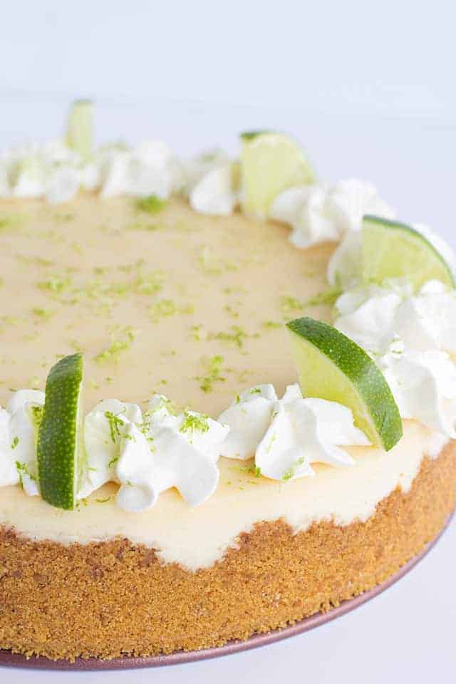 Key Lime Cheesecake - This key lime cheesecake is a fun spin on the key lime pie. It's so thick and creamy! Did I mention it has the perfect balance of sweet and tangy?! As far as the perfect summer dessert, this key lime cheesecake is the total package. #cookiedoughandovenmitt #cheesecake #cheesecakes #summerdessert #dessertfoodrecipes #dessertrecipes