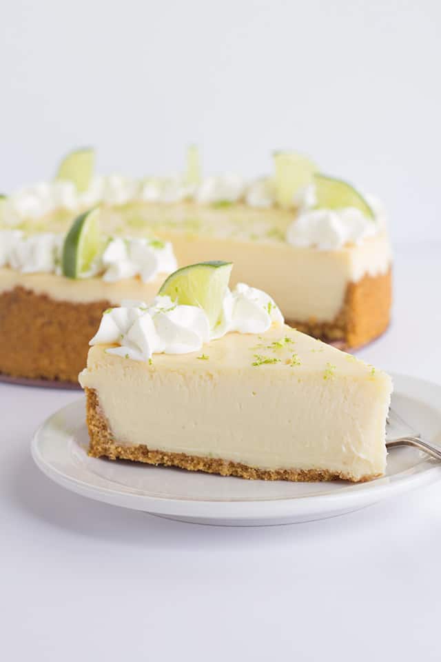 Key Lime Cheesecake - This key lime cheesecake is a fun spin on the key lime pie. It's so thick and creamy! Did I mention it has the perfect balance of sweet and tangy?! As far as the perfect summer dessert, this key lime cheesecake is the total package. #cookiedoughandovenmitt #cheesecake #cheesecakes #summerdessert #dessertfoodrecipes #dessertrecipes