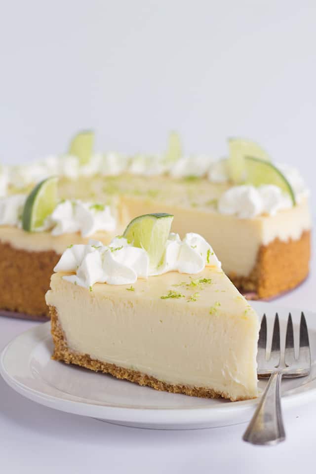 Key Lime Cheesecake - This key lime cheesecake is a fun spin on the key lime pie. It's so thick and creamy! Did I mention it has the perfect balance of sweet and tangy?! As far as the perfect summer dessert, this key lime cheesecake is the total package. #cookiedoughandovenmitt #cheesecake #cheesecakes #summerdessert #dessertfoodrecipes #dessertrecipes
