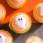 Ghost cupcakes with a dark wood and orange background