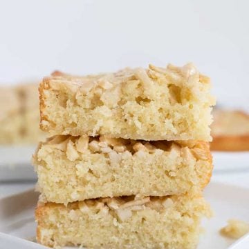 Squares of swedish visiting cake bars stacked on a small square plate