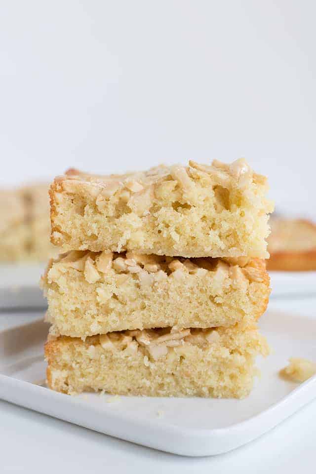 Squares of swedish visiting cake bars stacked on a small square plate