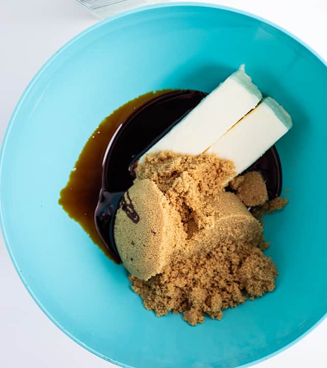 Baking sticks, brown sugar, and molasses in a blue bowl