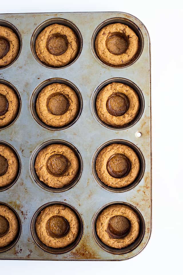 Fudge Filled Gingerbread Cookie Cups - There's nothing better than a tasty Christmas cookie this time of the year! These fudge filled gingerbread cookie cups will not disappoint. They're chewy, loaded with flavor, and filled with an easy buttered rum fudge.