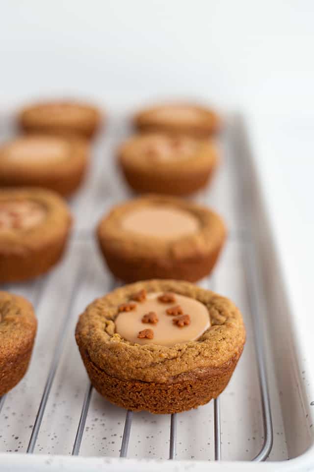 Fudge Filled Gingerbread Cookie Cups - There's nothing better than a tasty Christmas cookie this time of the year! These fudge filled gingerbread cookie cups will not disappoint. They're chewy, loaded with flavor, and filled with an easy buttered rum fudge.