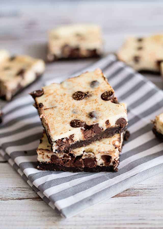 stack of eggnog cheesecake bars on a linen