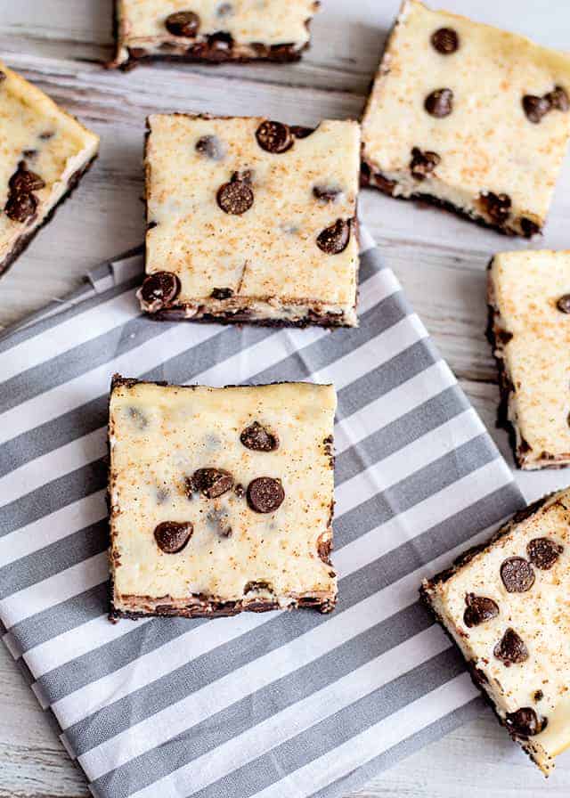 Eggnog cheesecake bars on a striped napkin.