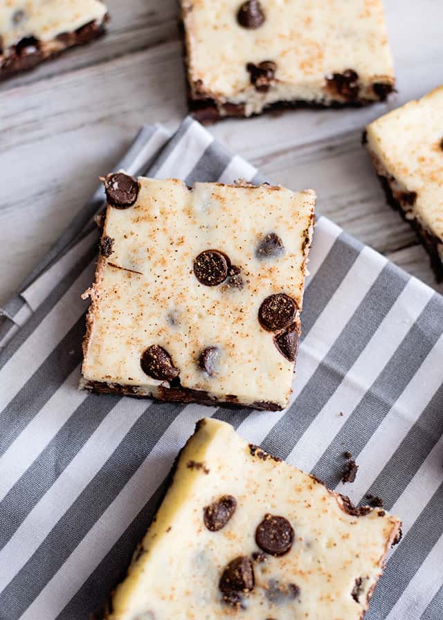 eggnog cheesecake bars on a striped linen