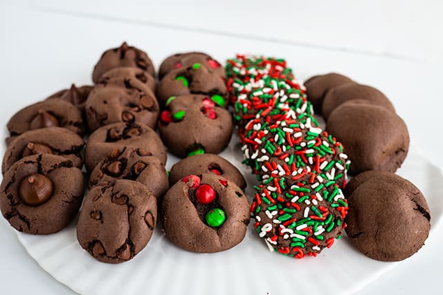 Close up of chocolate cake mix cookies with all five types on white platter