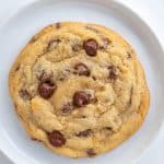Close up chocolate chip cookie on a white plate