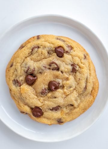 Close up chocolate chip cookie on a white plate